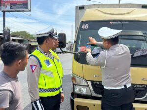Satlantas Polres Batu Bara Sosialisasikan dan Tempel Stiker Operasi Patuh Toba 2025 di Simpang Empat Lima Puluh